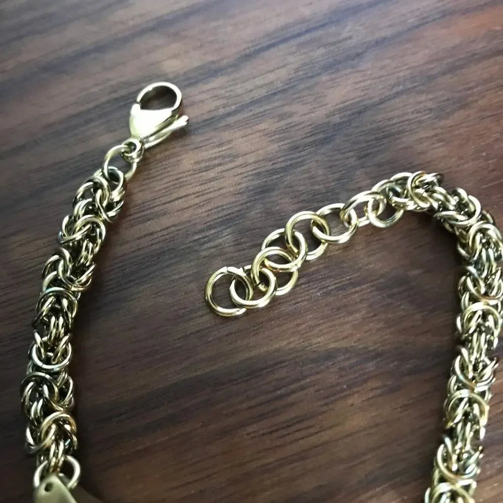 Brushed gold tone bracelet w/ a compartment for a fitbit device